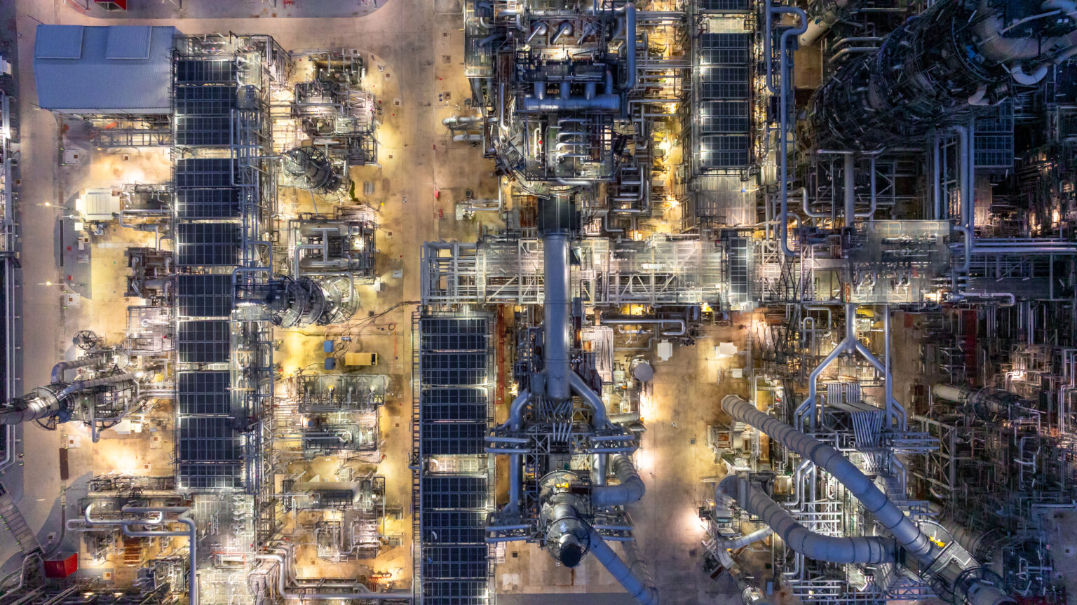 Aerial top view petrochemical plant oil refinery storage tank pipe line at night, Petroleum oil refinery industrial infrastructure oil storage tank, Oil refinery petrochemical industrial chemical.