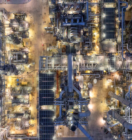 Aerial top view petrochemical plant oil refinery storage tank pipe line at night, Petroleum oil refinery industrial infrastructure oil storage tank, Oil refinery petrochemical industrial chemical.